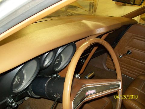 1972 Ford Mustang - The interior of a car is shown, focusing on the dashboard, steering wheel, and gauges.