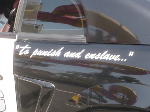 1990 Ford Probe - A white decal with text is applied to the side of a dark-colored vehicle.