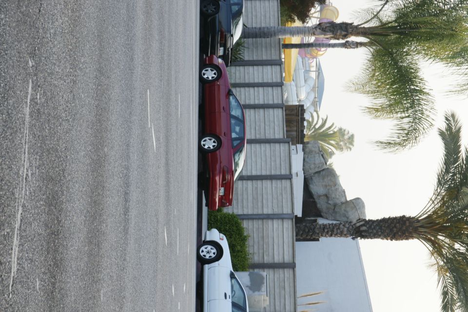 Side view of a red 1992 Ford Taurus parked in a lot