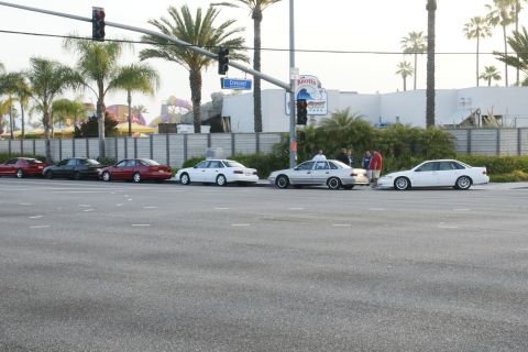 1992 Ford Taurus - A line of sedans, including a 1992 Ford Taurus, parked near Knott's Berry Farm.