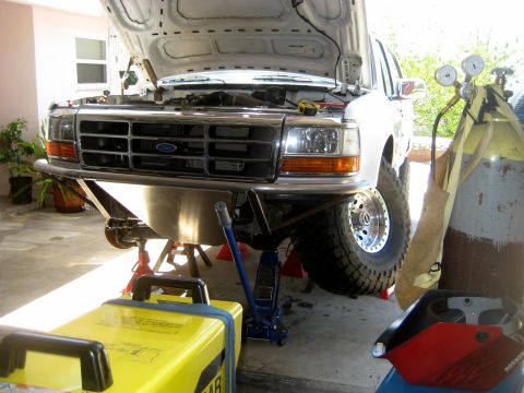 1996 Ford Bronco - 1996 Ford Bronco front suspension work in progress with welding gear present.