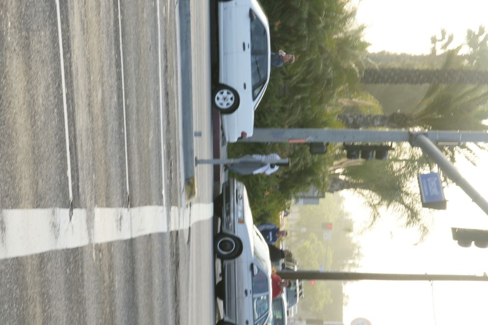 white sedan and silver sedan at intersection