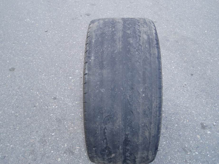 Worn tire on asphalt