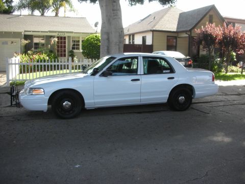 2004 Ford Crown Victoria - Side view of a white 2004 Ford Crown Victoria sedan.