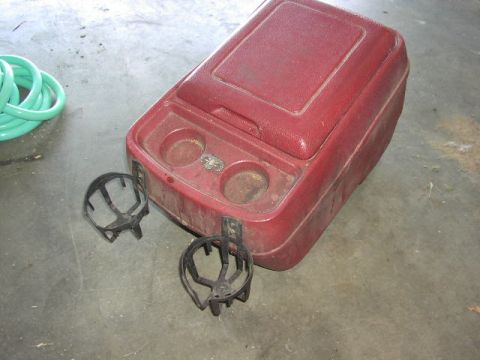1981 Ford Bronco - Center console part with cup holders and storage, alongside loose cup holder inserts.