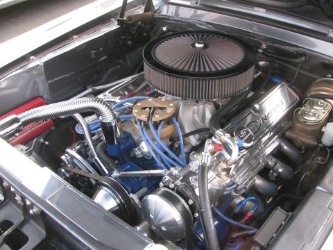 1996 Ford C-350 (Centurion Conversions) - Detailed view of a modified engine bay, showing custom components and polished metal accents.
