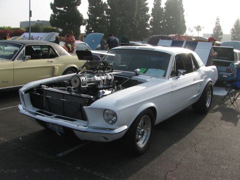 1996 Ford C-350 (Centurion Conversions) - White 1967 Ford Mustang with a prominent supercharger and racing stripes at a car show.