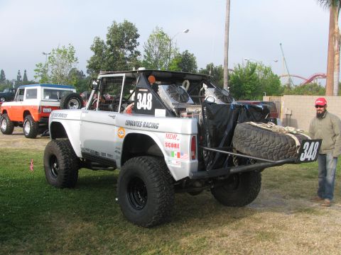 1996 Ford C-350 (Centurion Conversions) - Modified Ford Bronco with racing decals and a spare tire mounted at the rear, seen with another Bronco in the background.