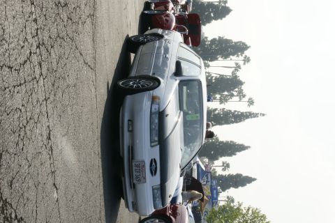 1992 Ford Taurus - A white 1992 Ford Taurus is parked at an outdoor event with other vehicles and trees in the background.