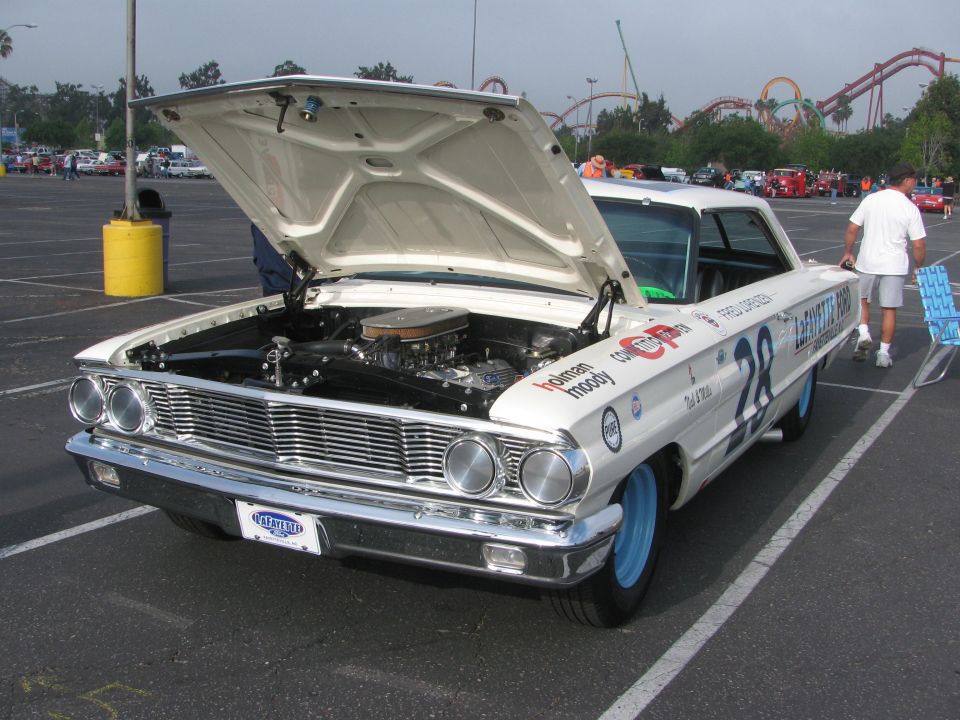 1963 Ford Galaxie 500 lightweight race car with hood open, number 28 on door, blue wheels