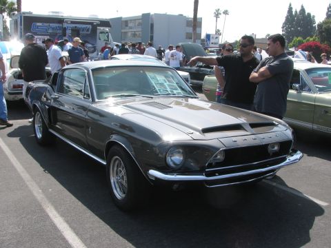 1996 Ford C-350 (Centurion Conversions) - A classic Shelby GT500 is displayed at an outdoor car show with spectators nearby.