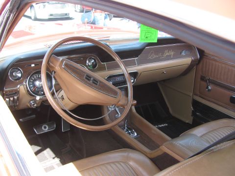 1996 Ford C-350 (Centurion Conversions) - The interior of a classic Shelby GT350 features a wood-grain dashboard and tan upholstery.