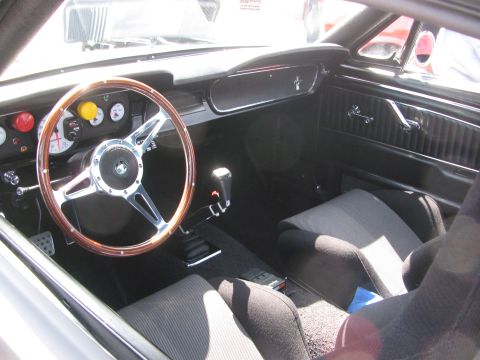 1996 Ford C-350 (Centurion Conversions) - Custom interior with racing seats and a wood-rimmed steering wheel.