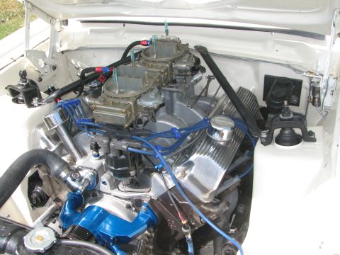 1996 Ford C-350 (Centurion Conversions) - Engine bay of a white vehicle with a V8 engine, dual carburetors, and custom blue accents.