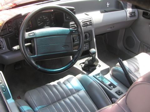 1996 Ford C-350 (Centurion Conversions) - Interior view of a car, likely from the early 1990s, with a manual transmission and gray leather seats.