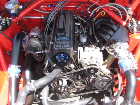 1996 Ford C-350 (Centurion Conversions) - Close-up of a modified Ford 2.3L Turbo engine, showing the turbocharger and fuel injection components.