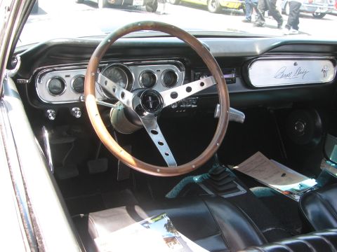 1996 Ford C-350 (Centurion Conversions) - Interior view of a 1965 Ford Mustang, showing the dashboard, steering wheel, and seats.