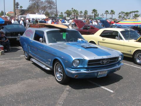 1996 Ford C-350 (Centurion Conversions) - Custom 1965 Ford Mustang "SportsRoof" wagon conversion with surfboard, seen at a car show.
