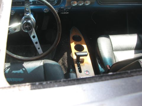 1996 Ford C-350 (Centurion Conversions) - The interior of a vehicle features a wooden center console and a classic steering wheel.