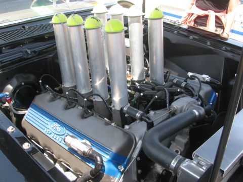 1996 Ford C-350 (Centurion Conversions) - Custom intake stacks on a Ford V8 engine, each topped with a tennis ball.