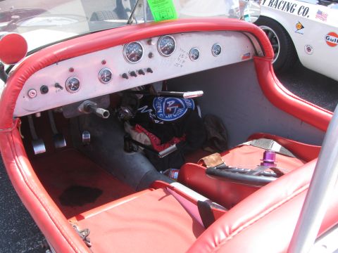 1996 Ford C-350 (Centurion Conversions) - Interior view of a custom hot rod, showing gauges and red upholstery. A second vehicle is visible in the background.