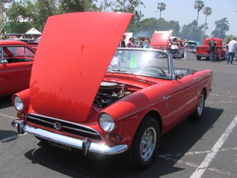1996 Ford C-350 (Centurion Conversions) - A red convertible sports car is displayed with its hood open at an outdoor event.