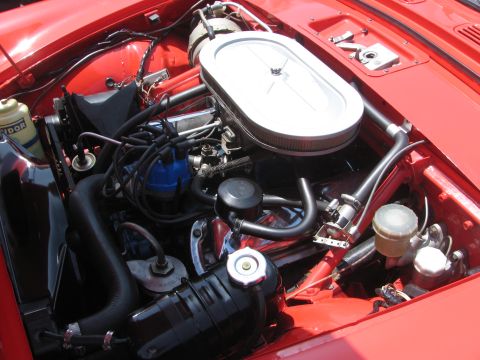 1996 Ford C-350 (Centurion Conversions) - Close-up view of a red vehicle's engine bay, showing various components and wiring.