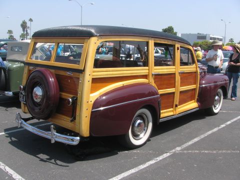 1996 Ford C-350 (Centurion Conversions) - Rear view of a classic woodie station wagon parked in a lot.