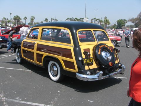1996 Ford C-350 (Centurion Conversions) - Woodie station wagon parked at an outdoor car show with other vehicles visible.