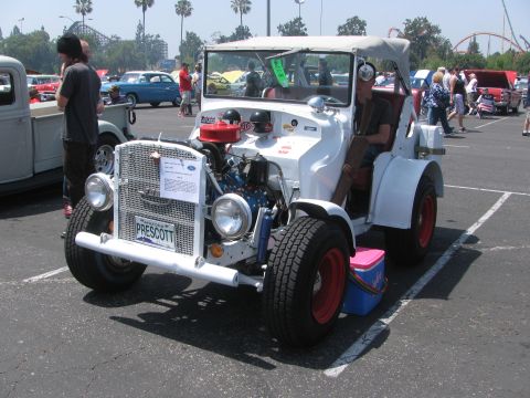 1996 Ford C-350 (Centurion Conversions) - A custom-built hot rod is parked in a lot, its engine and unique design.
