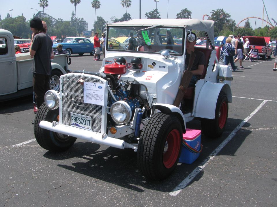 White custom hot rod with exposed engine, red wheels, and a "PRESCOTT" license plate
