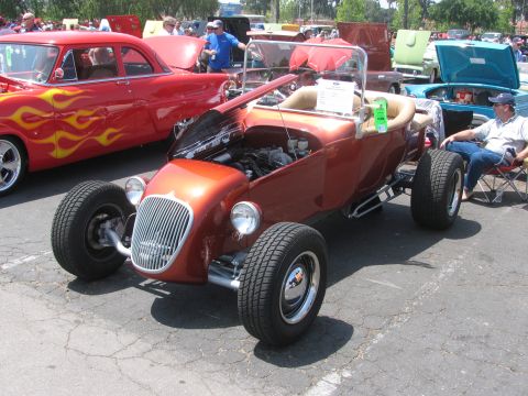 1996 Ford C-350 (Centurion Conversions) - A custom hot rod is displayed at an outdoor event with other vehicles and spectators.