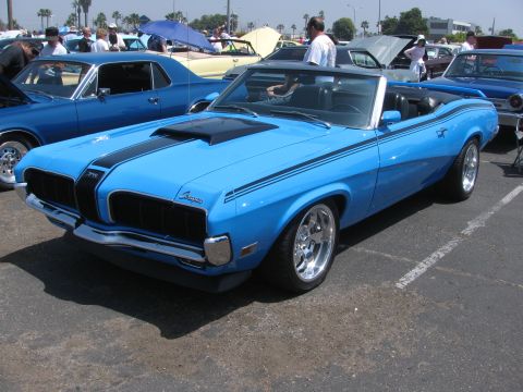 1996 Ford C-350 (Centurion Conversions) - A blue 1969 Mercury Cougar convertible is parked in a lot with other cars.