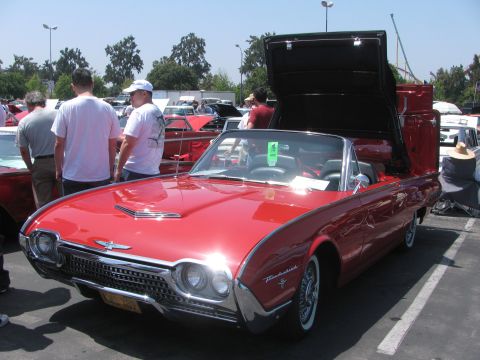 1996 Ford C-350 (Centurion Conversions) - A red 1961 Ford Thunderbird convertible is displayed with its top in the raised position.