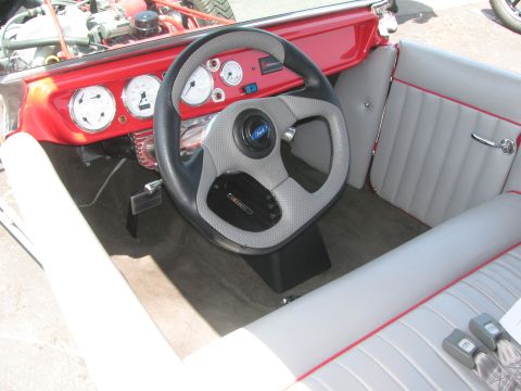 1996 Ford C-350 (Centurion Conversions) - Custom hot rod interior features a Ford steering wheel and multiple gauges on the dashboard.