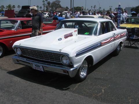 1996 Ford C-350 (Centurion Conversions) - This white 1963 Ford Falcon features patriotic American flag graphics along its side and a prominent racing hood scoop.