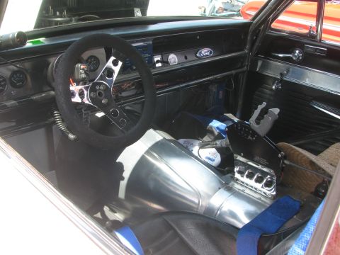 1996 Ford C-350 (Centurion Conversions) - Interior view of a modified vehicle, a Ford emblem on the dash and a racing-style shifter.