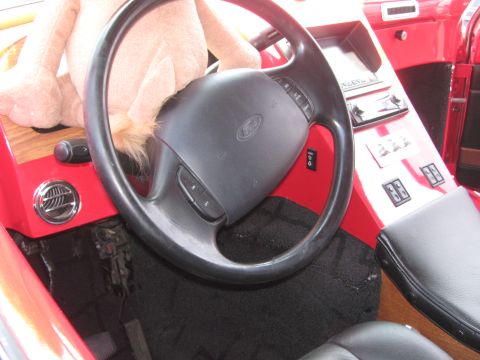 1996 Ford C-350 (Centurion Conversions) - Close-up of the driver's side interior of a 1996 Ford C-350 (Centurion Conversions) with a stuffed toy on the dashboard.