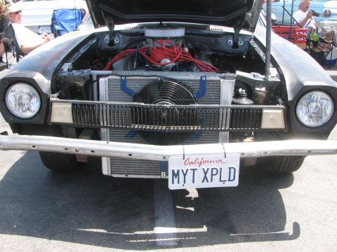1996 Ford C-350 (Centurion Conversions) - Front view of a black Ford Pinto with its hood open, revealing the engine and cooling system.