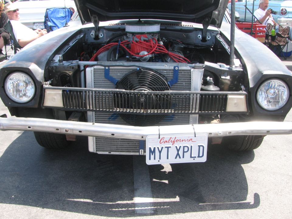 Black Ford Pinto with hood open, showing engine and radiator. California license plate MYT XPLD