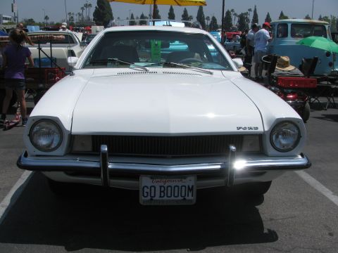 1996 Ford C-350 (Centurion Conversions) - This white Ford Pinto is seen from the front, a California license plate that reads 'GO BOOOM'.