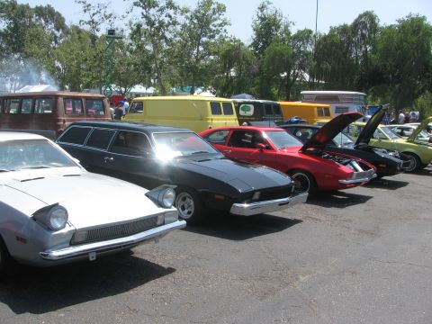 1996 Ford C-350 (Centurion Conversions) - A collection of vintage vehicles are lined up outdoors on a sunny day.