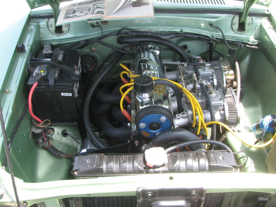 Engine bay with chrome valve cover and dual carburetors