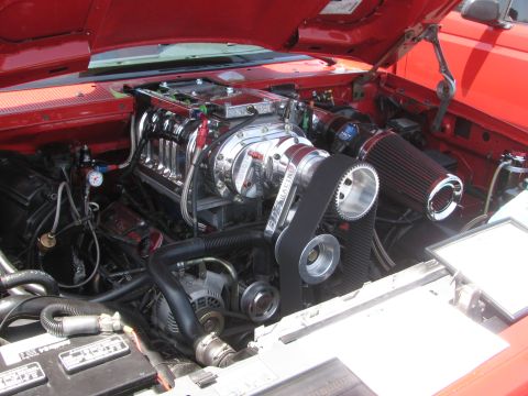 1996 Ford C-350 (Centurion Conversions) - Engine bay features a polished supercharger and prominent air intake system.