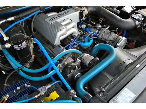 1994 Ford Bronco - The engine bay features a Ford Motorsport "Lightning" intake manifold and bright blue hoses.
