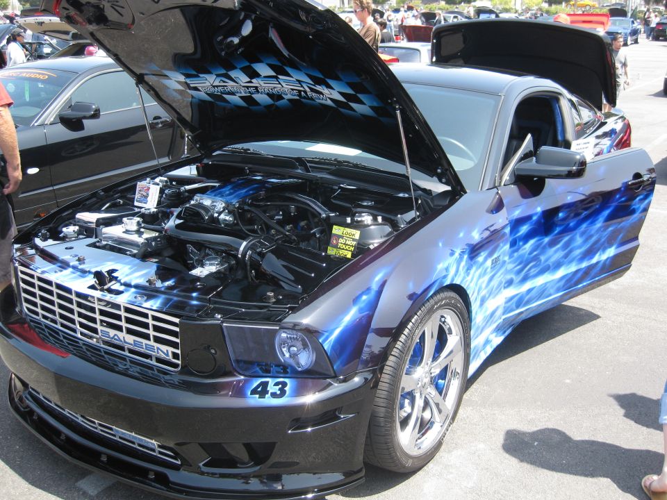 Custom Saleen Mustang with blue flames, hood and door open, showing engine. Number 43 on front