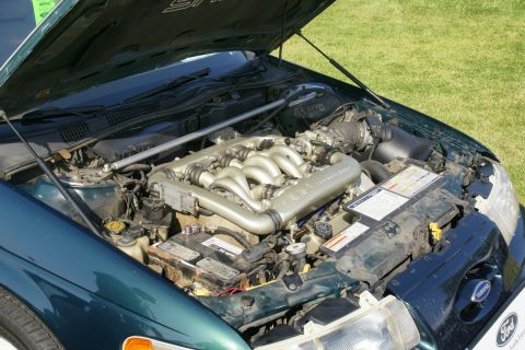 1992 Ford Taurus - The engine bay of a 1992 Ford Taurus, showing the V6 engine and other components under the open hood.