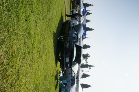 1992 Ford Taurus - A black 1992 Ford Taurus is displayed at an outdoor event with its trunk open.