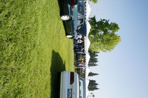 1992 Ford Taurus - Two cars are visible at an outdoor event, with tents and trees in the background.