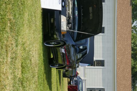 1992 Ford Taurus - Black 1992 Ford Taurus SHO on display at a car show, with its hood open.